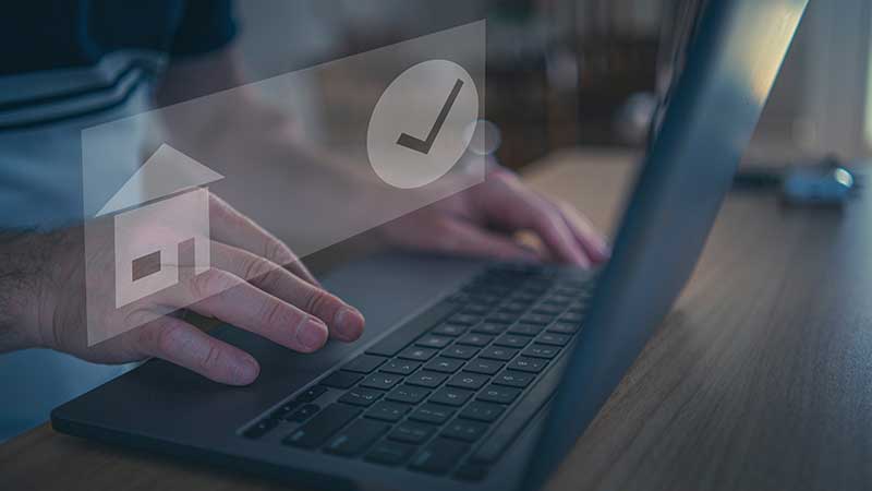 Homem no portátil com ícones de casa e visto